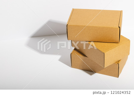 Stack of cardboard gift boxes with copy space over white background Stack of cardboard gift boxes with copy space over white background 121024352