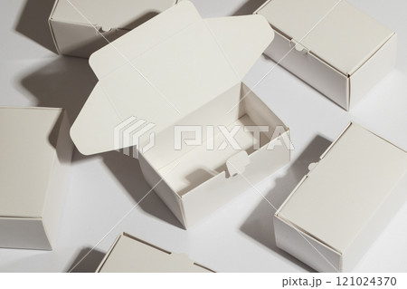 Open cardboard gift box and boxes with copy space over white background 121024370