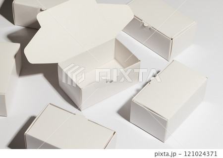Open cardboard gift box and boxes with copy space over white background Open cardboard gift box and boxes with copy space over white background 121024371