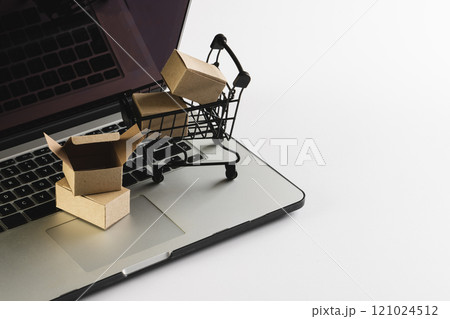 Laptop with blank screen, shopping trolley and gift boxes with copy space on white background Laptop with blank screen, shopping trolley and gift boxes with copy space on white background 121024512