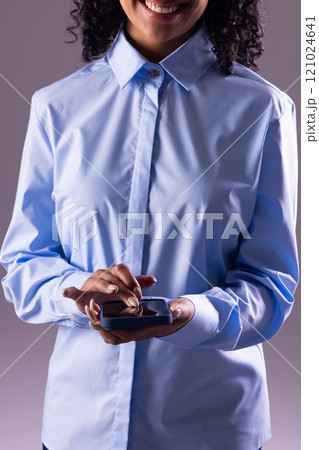 Vertical image of biracial businesswoman using smartphone with copy space on grey background Vertical image of biracial businesswoman using smartphone with copy space on grey background 121024641
