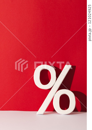 White percent sign with copy space against red background White percent sign with copy space against red background 121024925