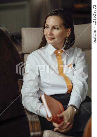 poised leader with a notebook, symbolizing planning and readiness. leader, engaged in strategic planning 121025372