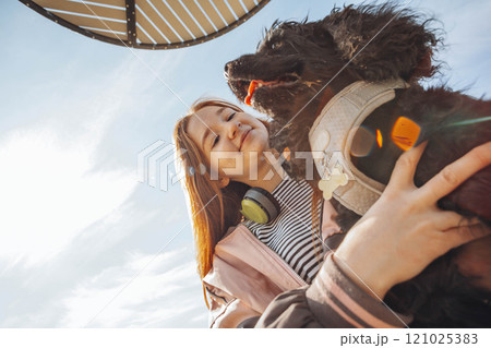 energetic moment showing the vibrancy of urban life, where the woman and her dog set out for a lively adventure together energetic moment showing the vibrancy of urban life, where the woman and her dog set out for a lively adventure together 121025383
