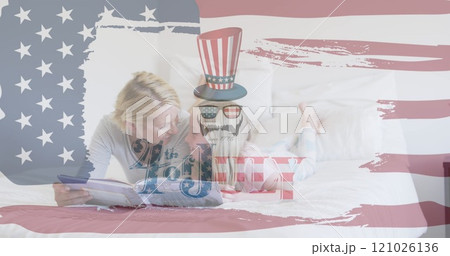 Independence text and american flag pattern against caucasian mother and daughter reading a book 121026136
