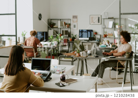 Young adult team working in modern office, they sitting at work desk with computers and programming 121028438