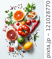 Fresh assortment of fruits and vegetables on white background with herbs and spices 121028770