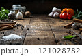 Rustic wooden table with various spices and fresh vegetables 121028782