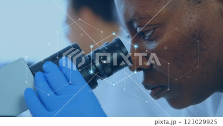 Image of network of connections over african american female scientist working in lab Image of network of connections over african american female scientist working in lab 121029925