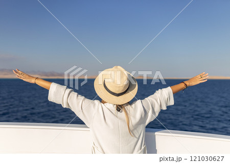 Elegant sexy woman in white dress standing near railings and looking on sunset. Like yacht style. Elegant sexy woman in white dress standing near railings and looking on sunset. Like yacht style. 121030627