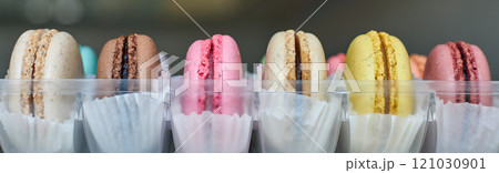 Banner of Bright French Macarons with white paperpan in a row Banner of Bright French Macarons with white paperpan in a row 121030901