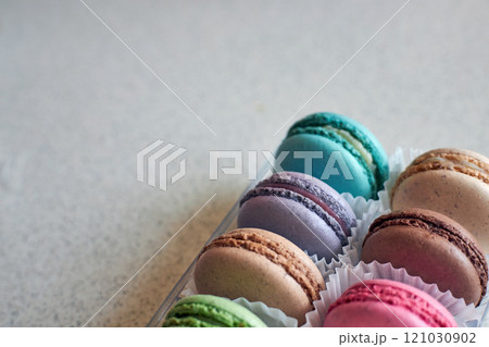Bright colorful cakes French Macarons with white paperpan in plastic box Bright colorful cakes French Macarons with white paperpan in plastic box 121030902
