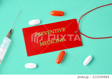 Importance of preventive medicine highlighted with colorful pills and a syringe on a vibrant background Importance of preventive medicine highlighted with colorful pills and a syringe on a vibrant background 121030984