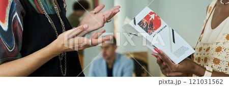 Hands of intercultural gallery visitors 121031562