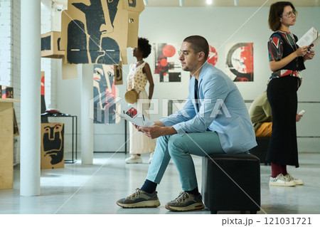 Man looking through list of expositions Man looking through list of expositions 121031721
