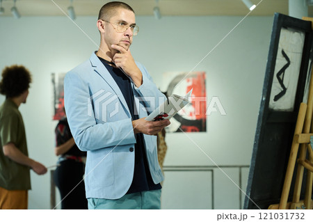 Man looking at artwork at exhibition Man looking at artwork at exhibition 121031732