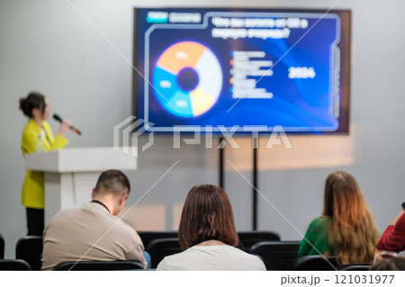 Speaker presenting data analysis to focused audience during conference session Speaker presenting data analysis to focused audience during conference session 121031977