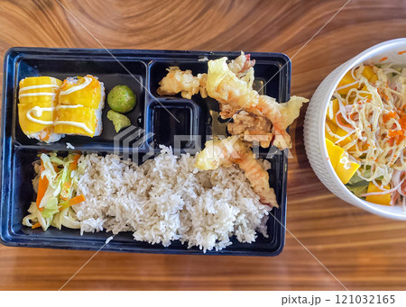 tempura shrimp with rice and mango rolls in a Japanese restaurant, salad with mango, crab and vegetables tempura shrimp with rice and mango rolls in a Japanese restaurant, salad with mango, crab and vegetables 121032165