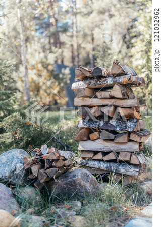 Firewood stacked outdoors. Camp firewood on nature Firewood stacked outdoors. Camp firewood on nature 121032962
