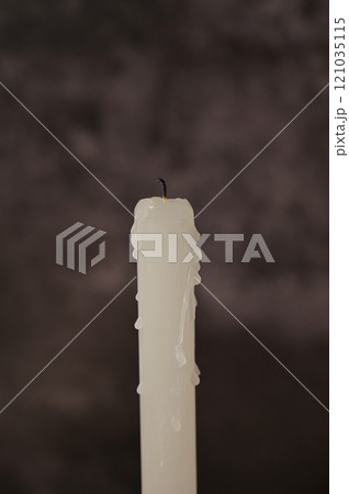Close-up one white blown out candle on dark gray background Close-up one white blown out candle on dark gray background 121035115