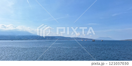 A serene view of the Bali Sea with calm blue waters and blue sky A serene view of the Bali Sea with calm blue waters and blue sky 121037030