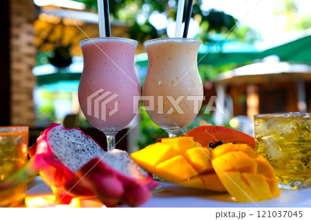 fresh fruit smoothies: strawberry banana smoothie, orange smoothie, green detox smoothie. Avocado juice. Fruit milkshake. Fresh strawberries. Wood table background. Natural sunlight. Healthy. fresh fruit smoothies: strawberry banana smoothie, orange smoothie, green detox smoothie. Avocado juice. Fruit milkshake. Fresh strawberries. Wood table background. Natural sunlight. Healthy. 121037045