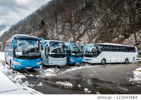 Intercity buses parked near the mountain forest at winter 121043668