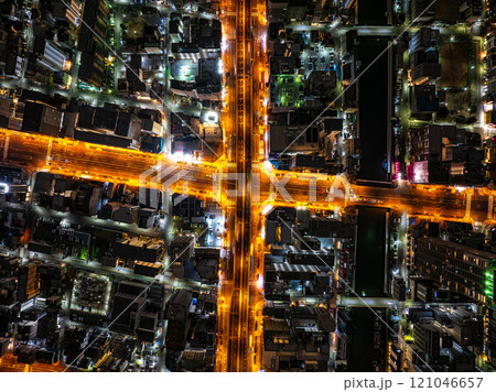 Nighttime Bird's eye view of Osaka's bustling streets layout, illuminated roads and dense buildings, capturing the vibrant energy of urban life in Japan 121046657