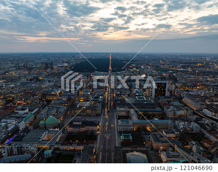 Berlin cityscape at dusk, aerial view of illuminated streets with traffic, Tiergarten Park, Alexanderplatz against a cloudy sky 121046690