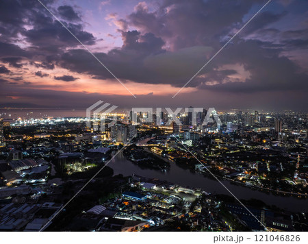 Manila skyline and Pasig River illuminated by a stunning sunset, with enchanting clouds adding a magical touch to the cityscape Manila skyline and Pasig River illuminated by a stunning sunset, with enchanting clouds adding a magical touch to the cityscape 121046826