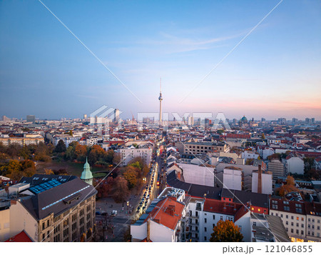 Aerial view of Berlin skyline in Autumn, featuring the iconic Fernsehturm television tower, surrounded by buildings and a park, with the berliner dom visible in the distance Aerial view of Berlin skyline in Autumn, featuring the iconic Fernsehturm television tower, surrounded by buildings and a park, with the berliner dom visible in the distance 121046855