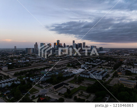 Captivating Houston skyline set against a stunning twilight cloudscape with warm tones, highlighting the city's dynamic urban landscape and contemporary infrastructure 121046863