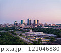 Aerial view of Fort Worth, Texas at dusk, vibrant cityscape, prominent skyscrapers, modern low residential buildings, active rail yard, and lush greenery 121046880