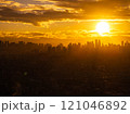 Golden hour in Manila, the sun sets behind the city's skyscrapers, casting a beautiful orange glow on the urban landscape 121046892