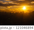 Stunning cityscape of Manila, Philippines with vibrant sunset and dramatic silhouettes created by warm sunlight on clouds and buildings 121046894