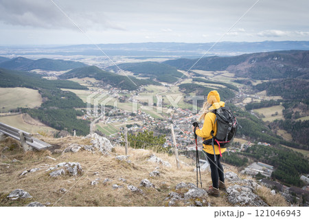 Female hiker enjoying the panoramic view on valley below from mountain summit, Austria, Europe 121046943