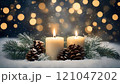 Burning christmas candles with pine cones and branches on snowy background 121047202