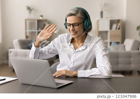 Positive friendly senior business woman meeting with colleagues on Internet Positive friendly senior business woman meeting with colleagues on Internet 121047986