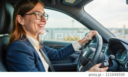 Woman driving car in business suit modern city background professional woman on road 121048500