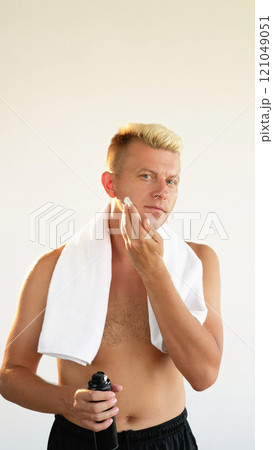 Stubble shaving. Grooming hygiene. Confident masculine man applying skin foam on clean face neck with hands isolated on white empty space background. Stubble shaving. Grooming hygiene. Confident masculine man applying skin foam on clean face neck with hands isolated on white empty space background. 121049051
