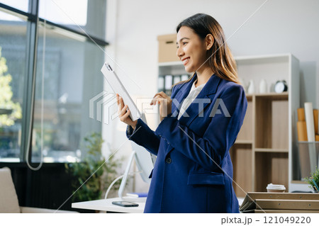 Confident business expert attractive smiling young woman holding digital tablet  on desk in creative Confident business expert attractive smiling young woman holding digital tablet  on desk in creative 121049220