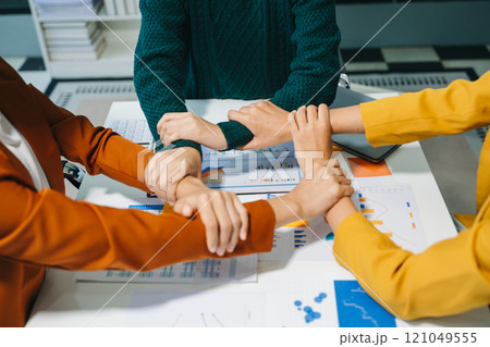 Close up on hands of business people join together their hands together on unity concept 121049555
