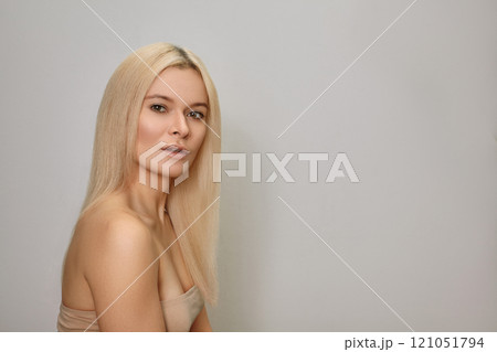 Woman with Straight Blond Hair. Keratin Treatment for Gloss Straight Hair Woman with Straight Blond Hair. Keratin Treatment for Gloss Straight Hair 121051794