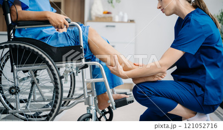 Physiotherapist helping elderly man patient stretching arm during exercise correct with dumbbell in hand during training hand with patient Back problems Physiotherapist helping elderly man patient stretching arm during exercise correct with dumbbell in hand during training hand with patient Back problems 121052716