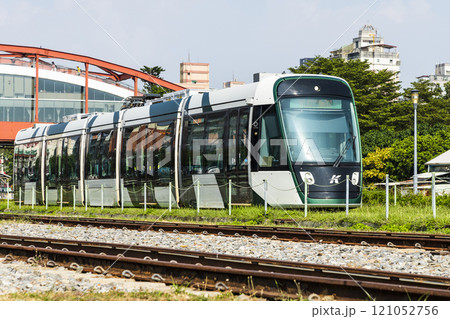 The circular light rail train drives past Hamasen Railway Cultural Park in Kaohsiung, Taiwan. 121052756