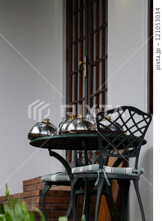 cleaning of hotel rooms and villas. plates covered metal lids on street table cleaning of hotel rooms and villas. plates covered metal lids on street table 121053034