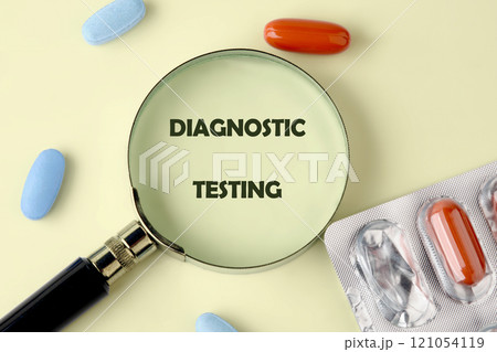 Magnifying glass highlighting diagnostic testing with pills and capsules on a light background 121054119