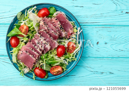 Salad with raw tuna , sesame and cherry tomatoes photography . Top view Salad with raw tuna , sesame and cherry tomatoes photography . Top view 121055699