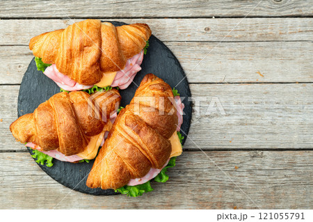 Croissant sandwich with salad ham and cheese . Top view 121055791