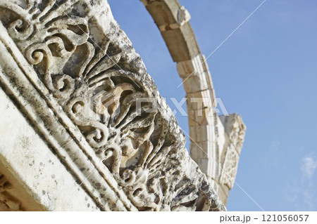Below view of ancient city ruins in a historical village. Traveling abroad and overseas for holiday, vacation, tourism. Low angle view of stone arch remains of old cultural buildings with history 121056057
